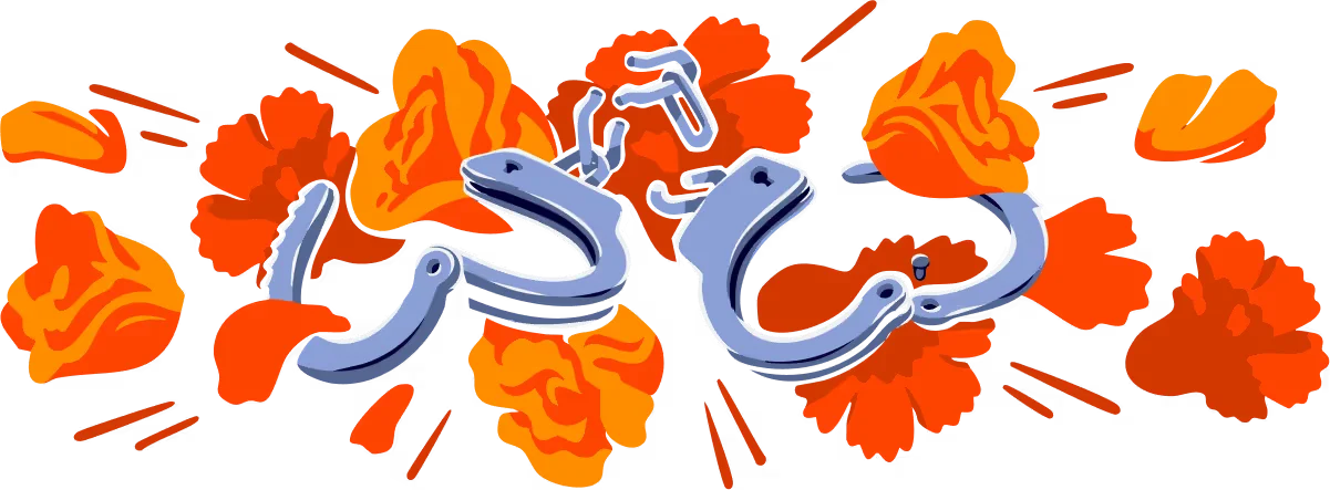 Broken handcuffs in front of red and orange flowers